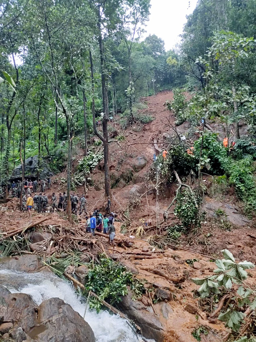 Army and NDRF personnel clear debris caused by a landslide during search and rescue operations at a flood-affected area, at Koottickal, in Kottayam on Sunday.