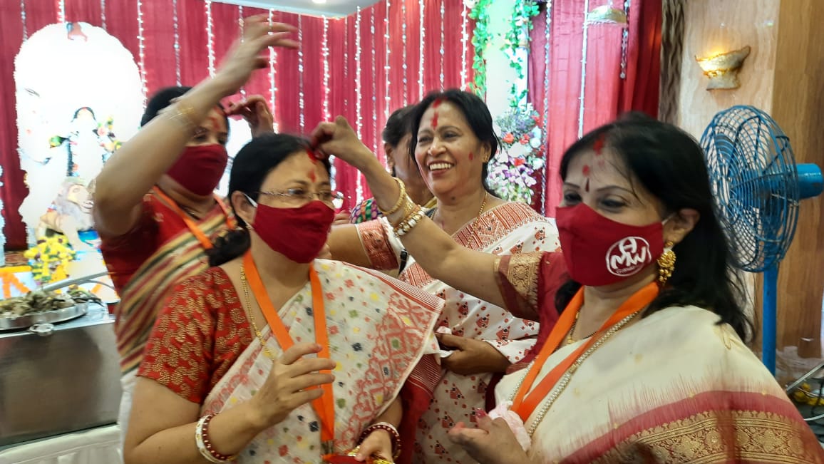 Women participate in Sindoor Khela at a puja pandal on the last day of Durga Puja celebrations in Mumbai, Friday, Oct. 15, 2021.