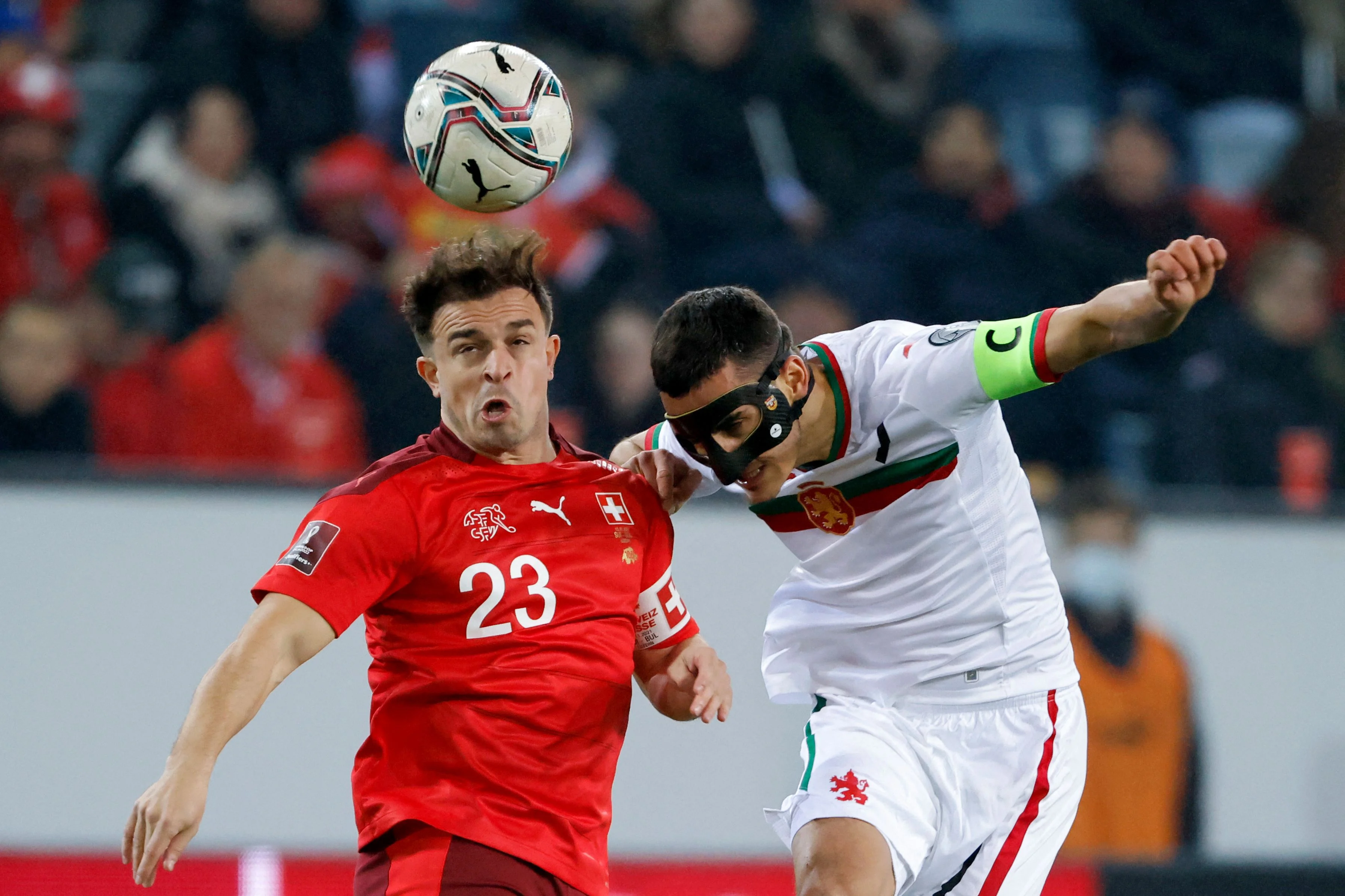 Swiss midfielder Xherdan Shaqiri (left) fights for the ball with Bulgaria's Georgi Kostadinov