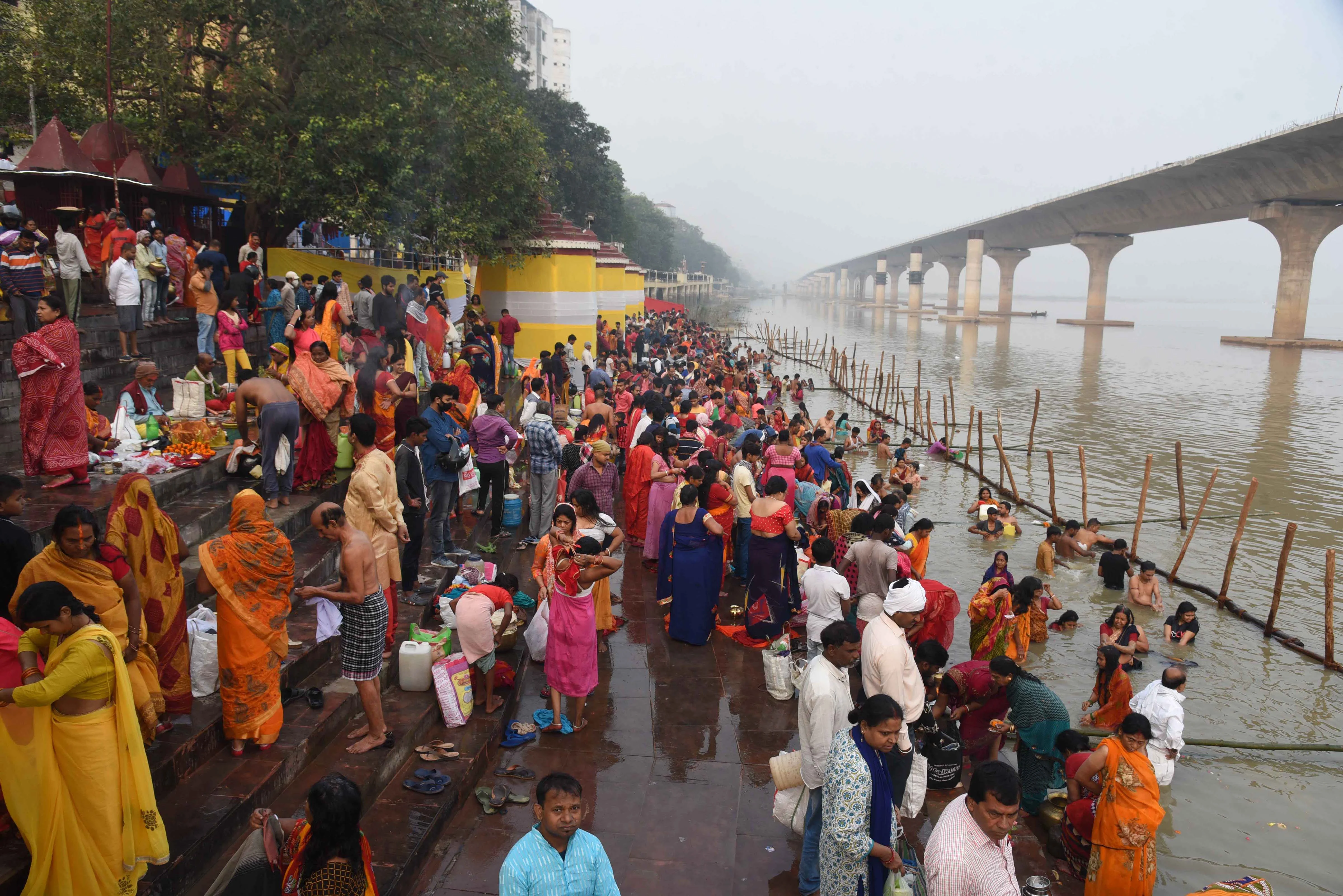 Devotees arrive at the banks of River Ganga during the first day of four days long Chhath Puja celebration, in Patna, Monday, Nov. 8, 2021.