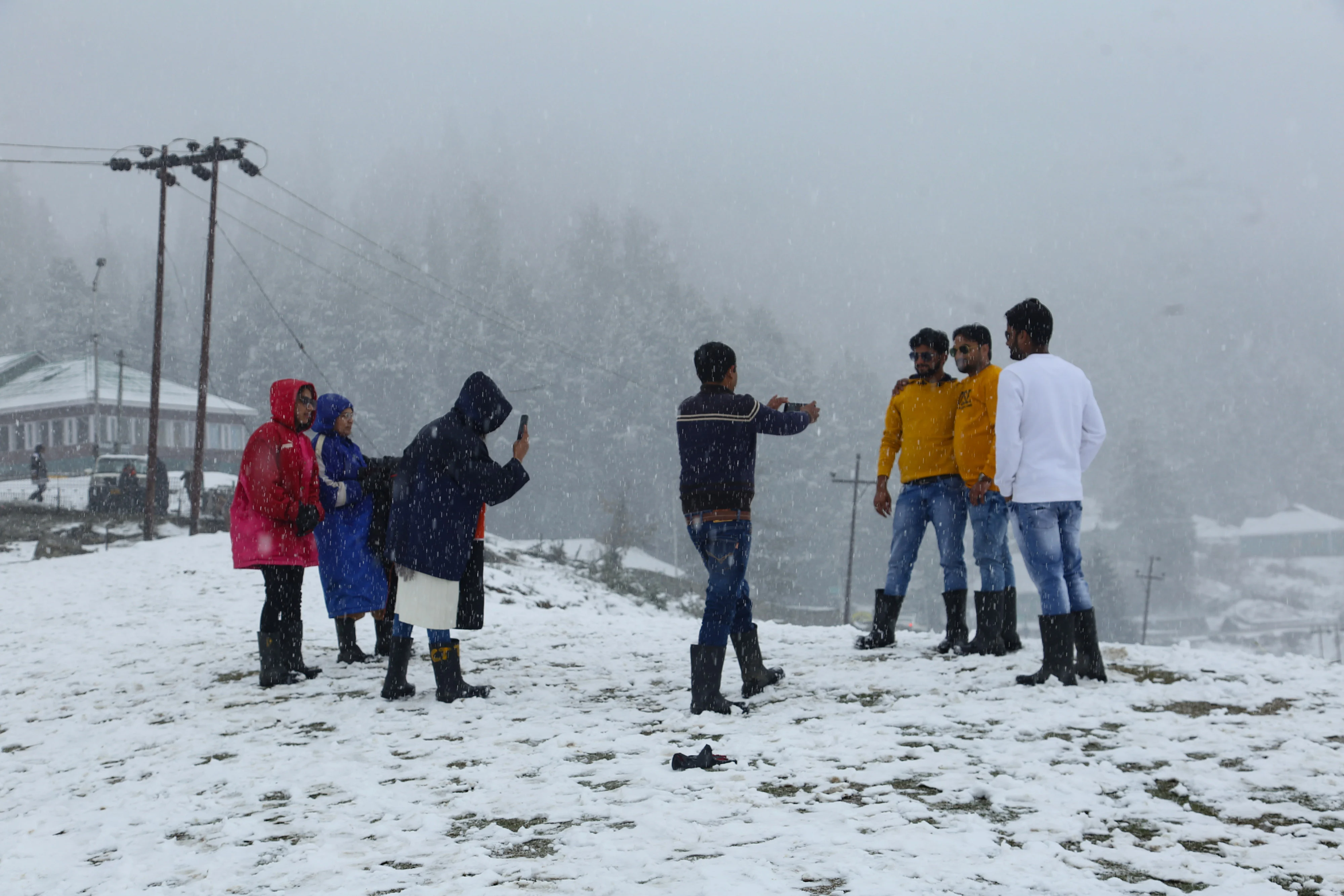 Tourists take selfie in snow at Ski resort in Gulmarg, Jammu and Kashmir on November 05, 2021.