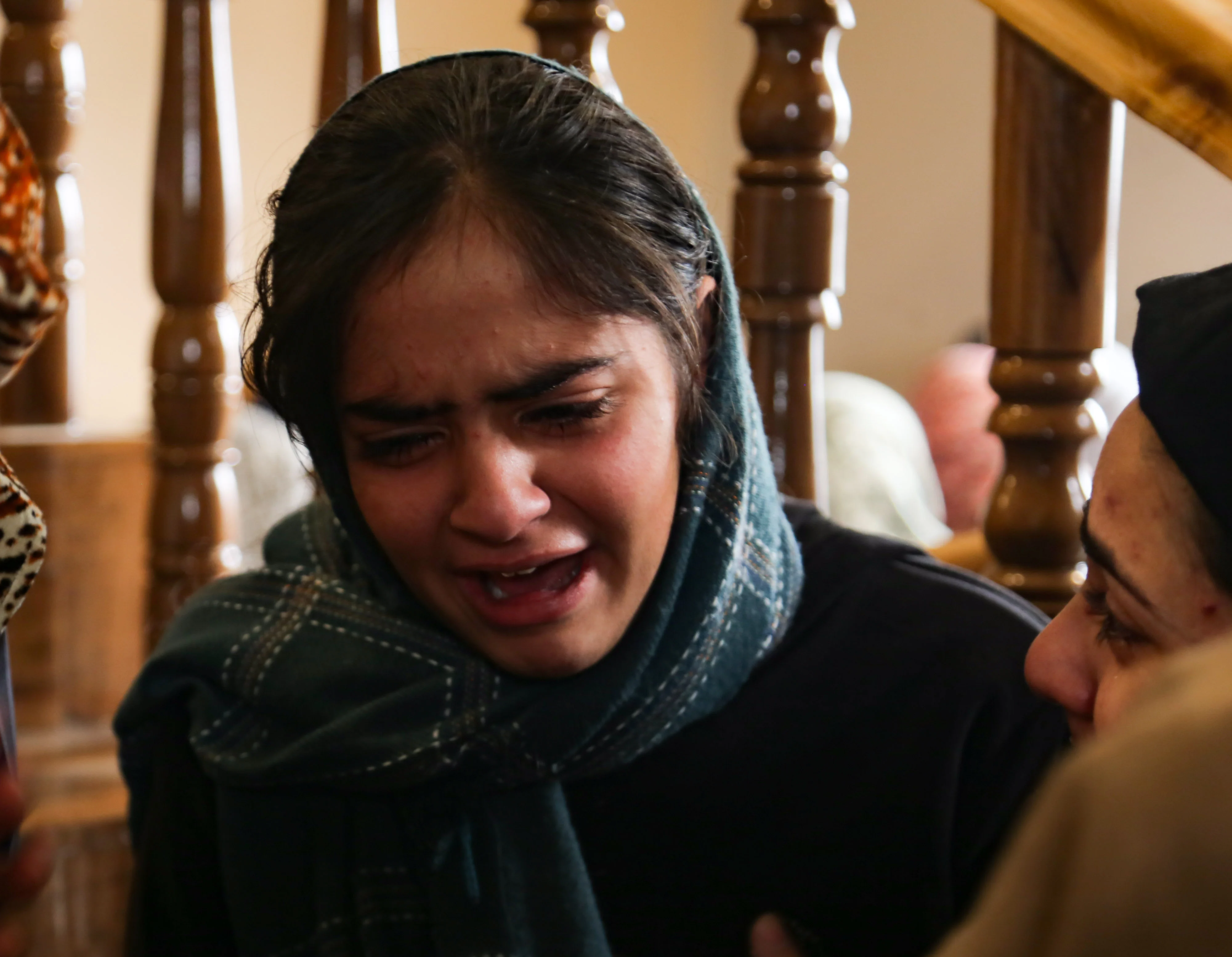 A girl weeps after her father Mohammad Altaf Bhat, the owner of a shopping centre, was killed in Srinagar, Kashmir.