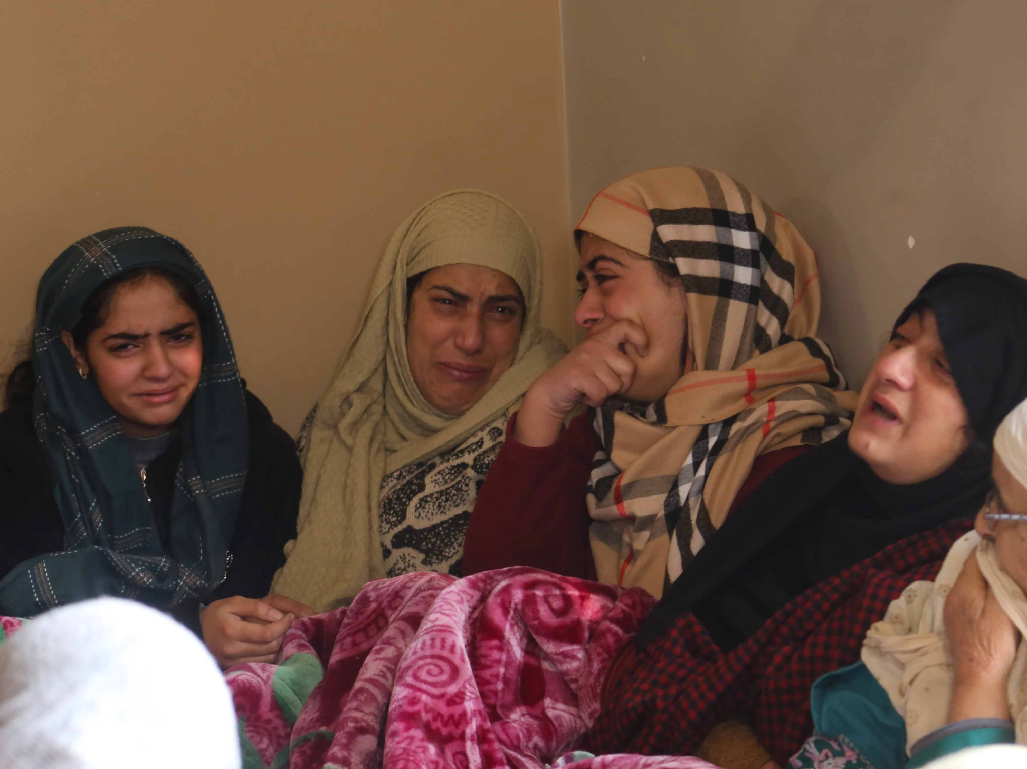 Family members mourn the killing of Mohammad Altaf Bhat, the owner of a shopping centre, in Srinagar, Kashmir.