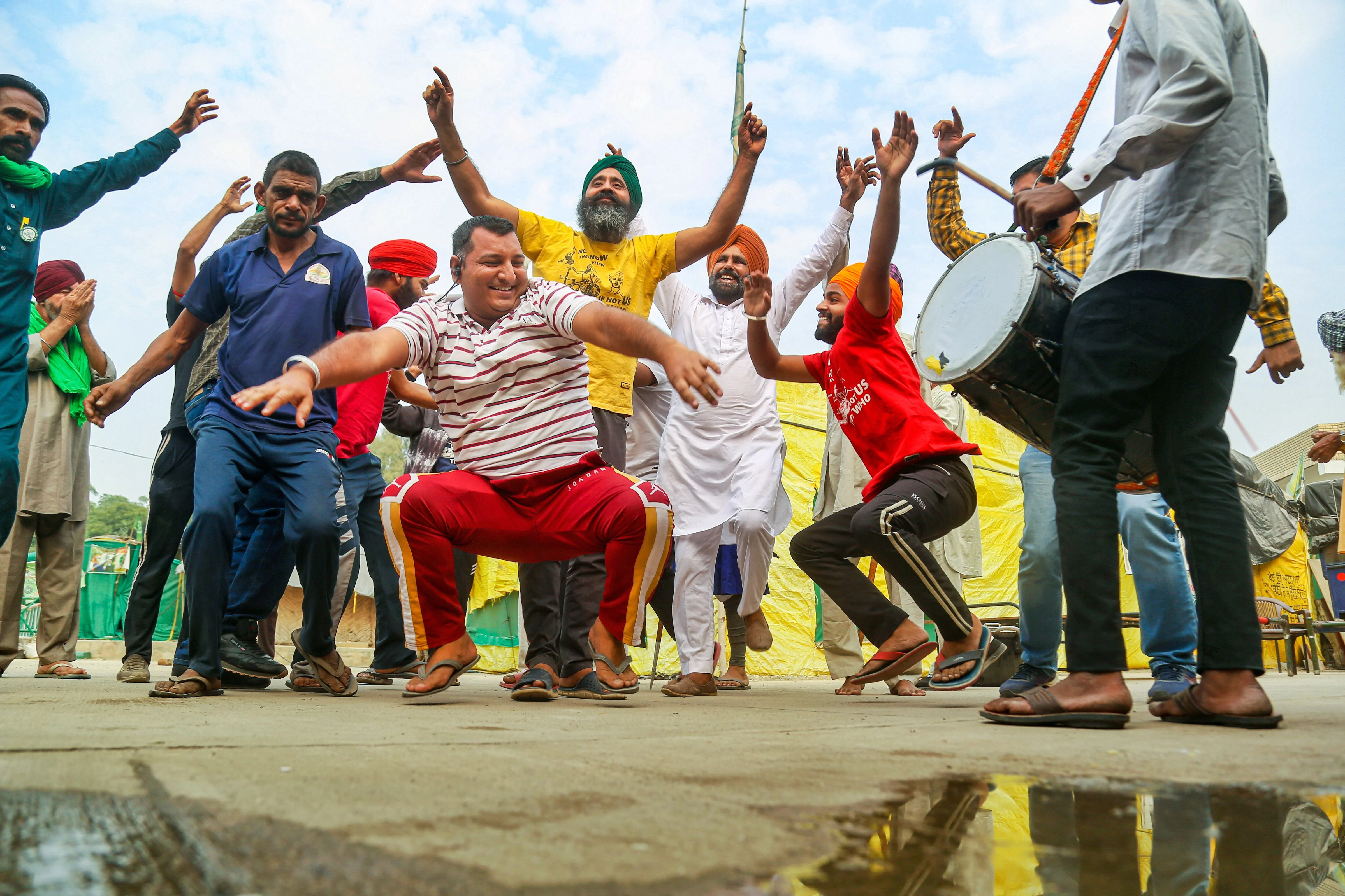 New Delhi: Farmers dance as they celebrate after Prime Minister Narendra Modi announced for the repealing of the three farm reform laws, at Tikri border in New Delhi, Friday, Nov. 19, 2021.