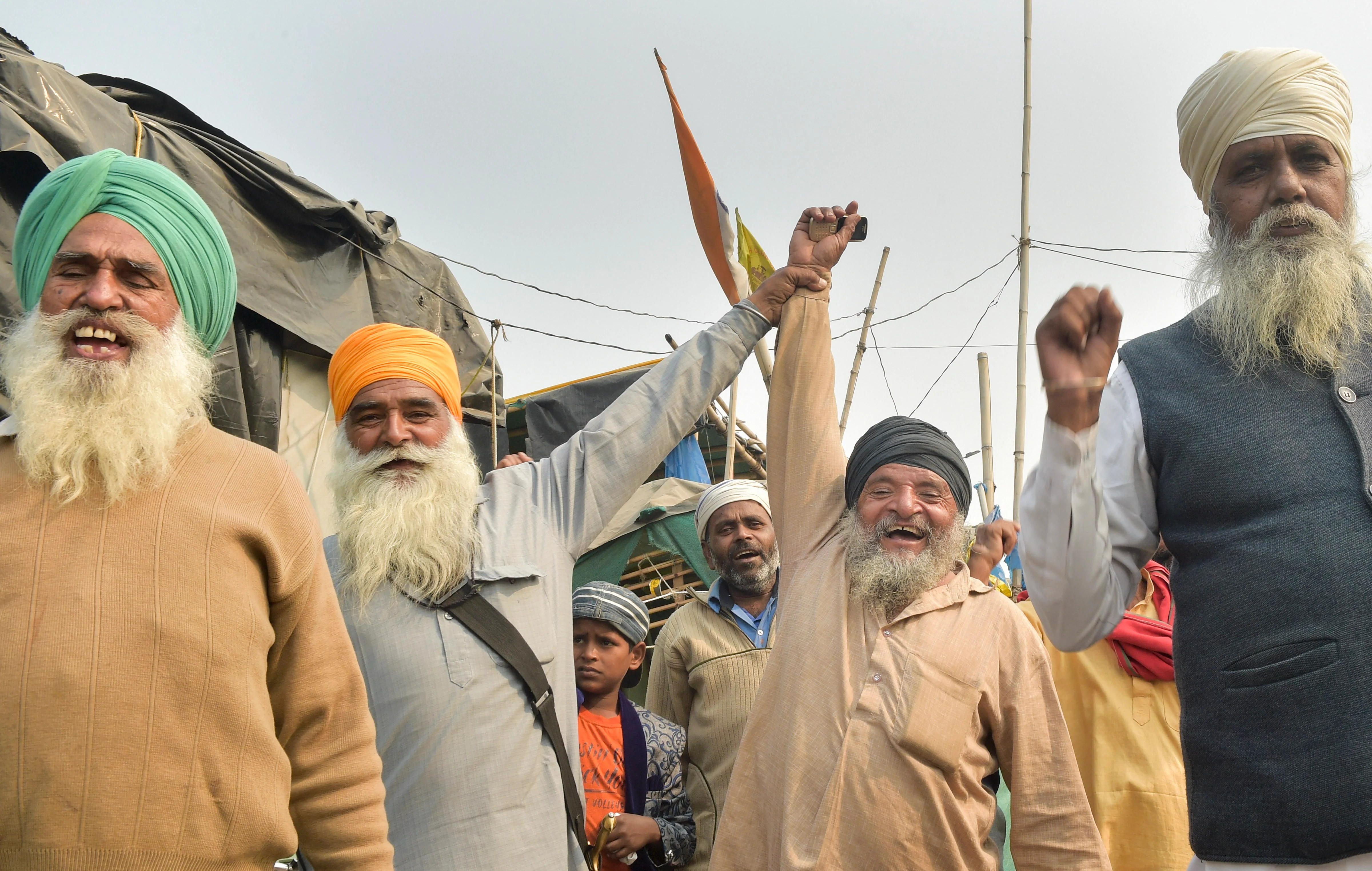 New Delhi: Farmers celebrate after Prime Minister Narendra Modi announced the repealing of the three Central farm laws, at Singhu Border in New Delhi, Friday, Nov. 19, 2021.