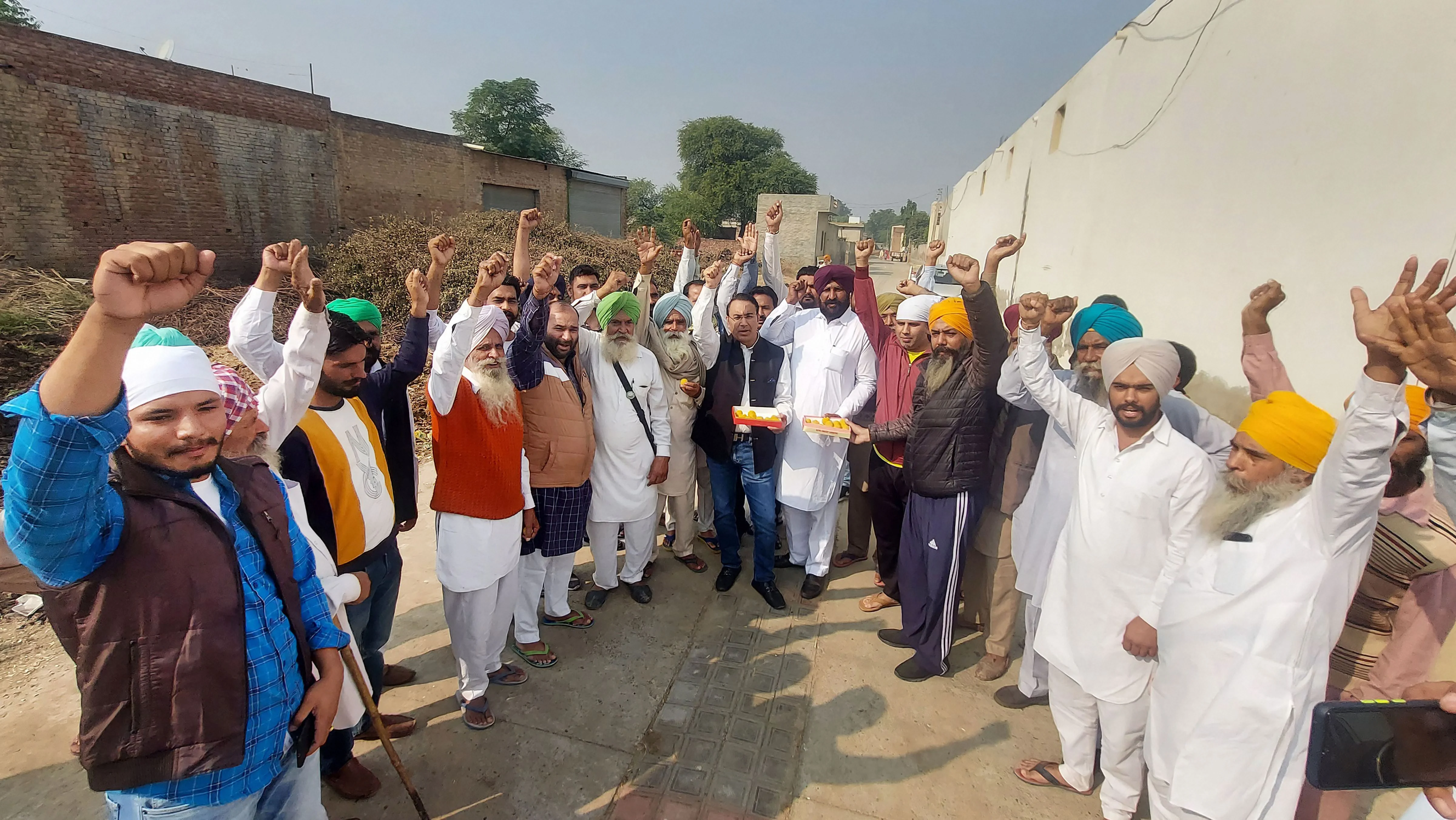 Bathinda: Farmers at Gill Patti village celebrate after Prime Minister Narendra Modi announced the repealing of the three Central farm laws, in Bathinda, Friday, Nov. 19, 2021.