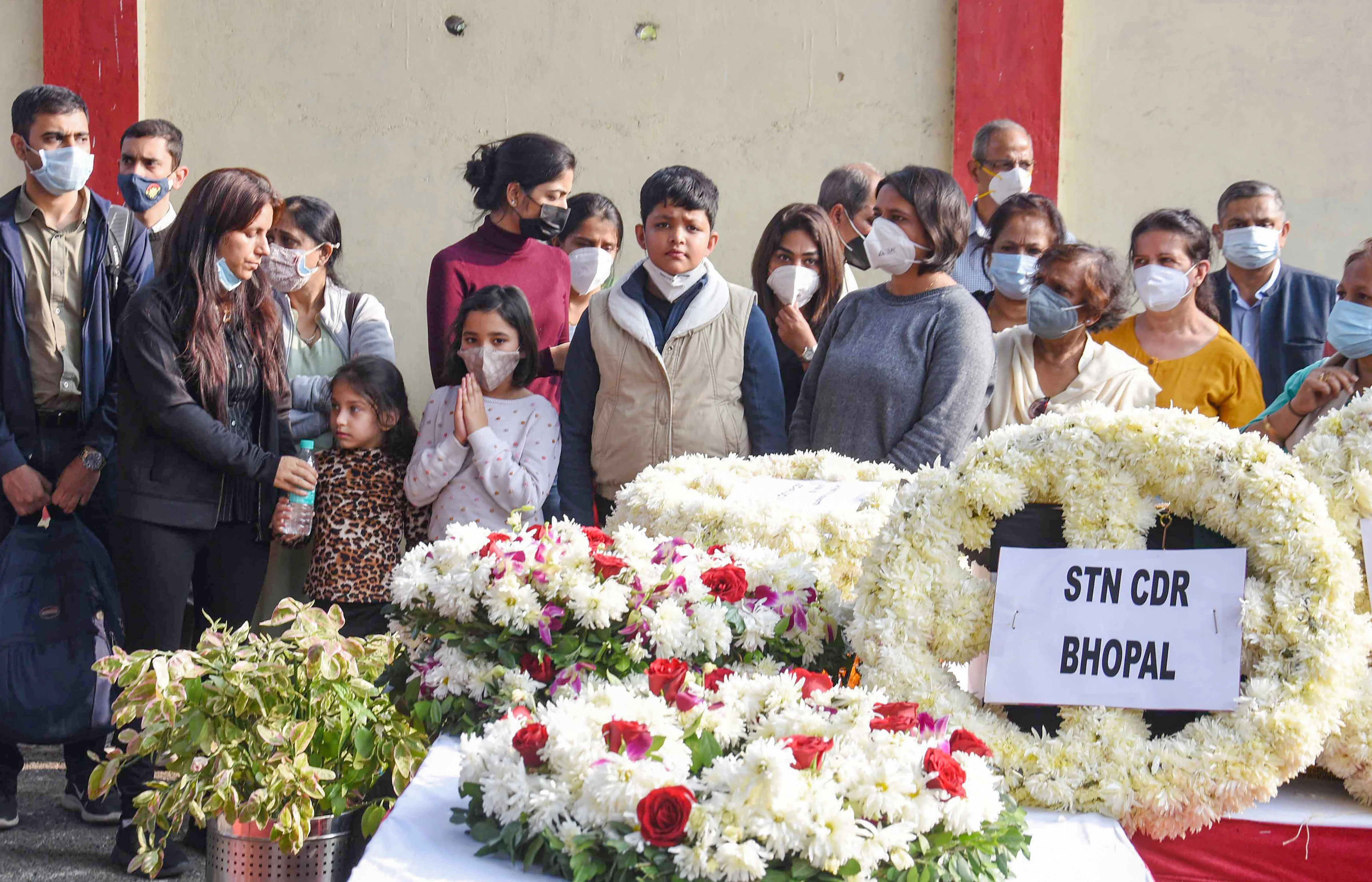 Family members and relative near the mortal remains of Group Captain Varun Singh near his residence in Bhopal, Thursday,