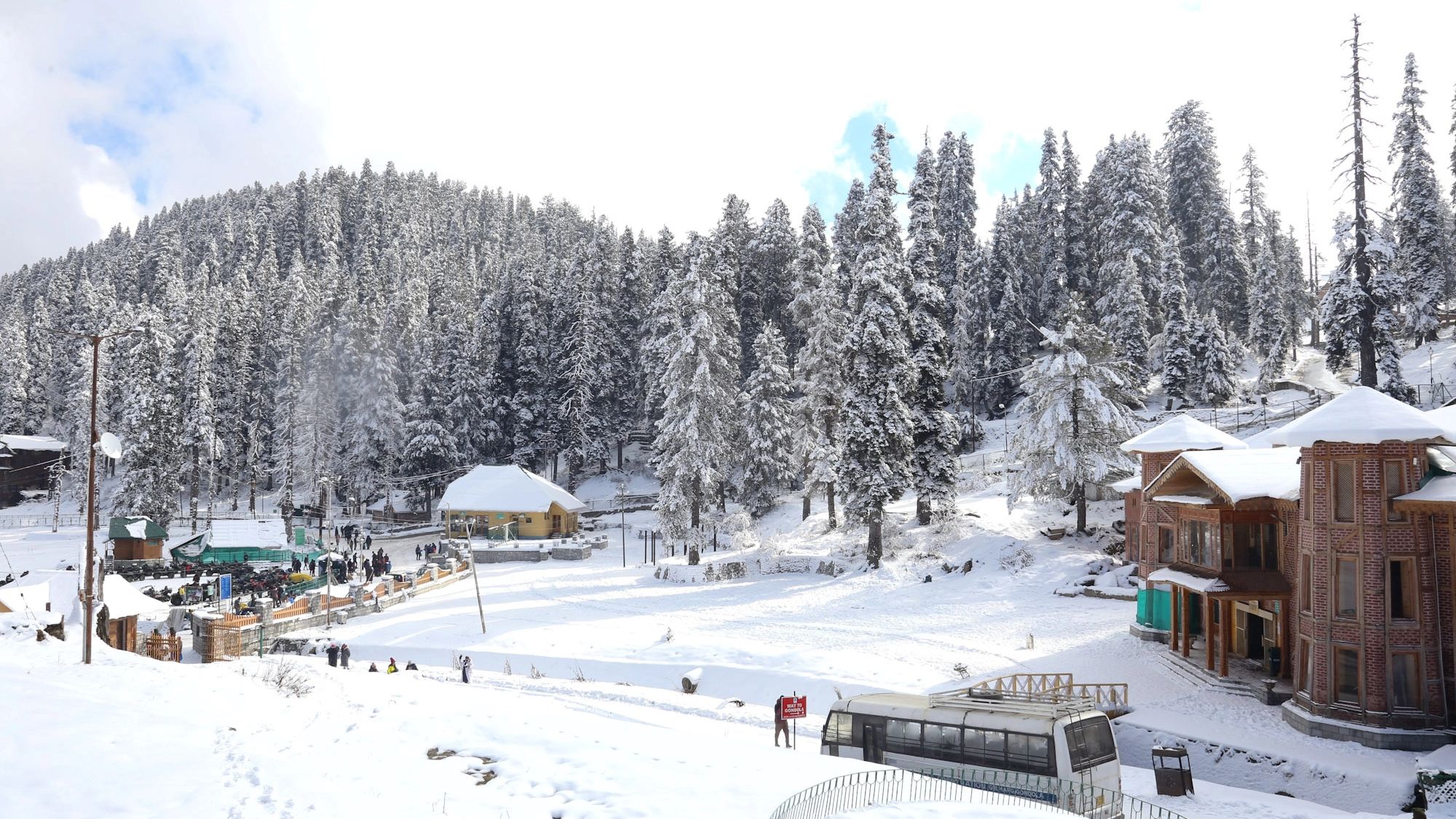 Trees are covered with the hoarfrost on a Sunny winter day at snow covered ski resort Gulmarg, Kashmir.