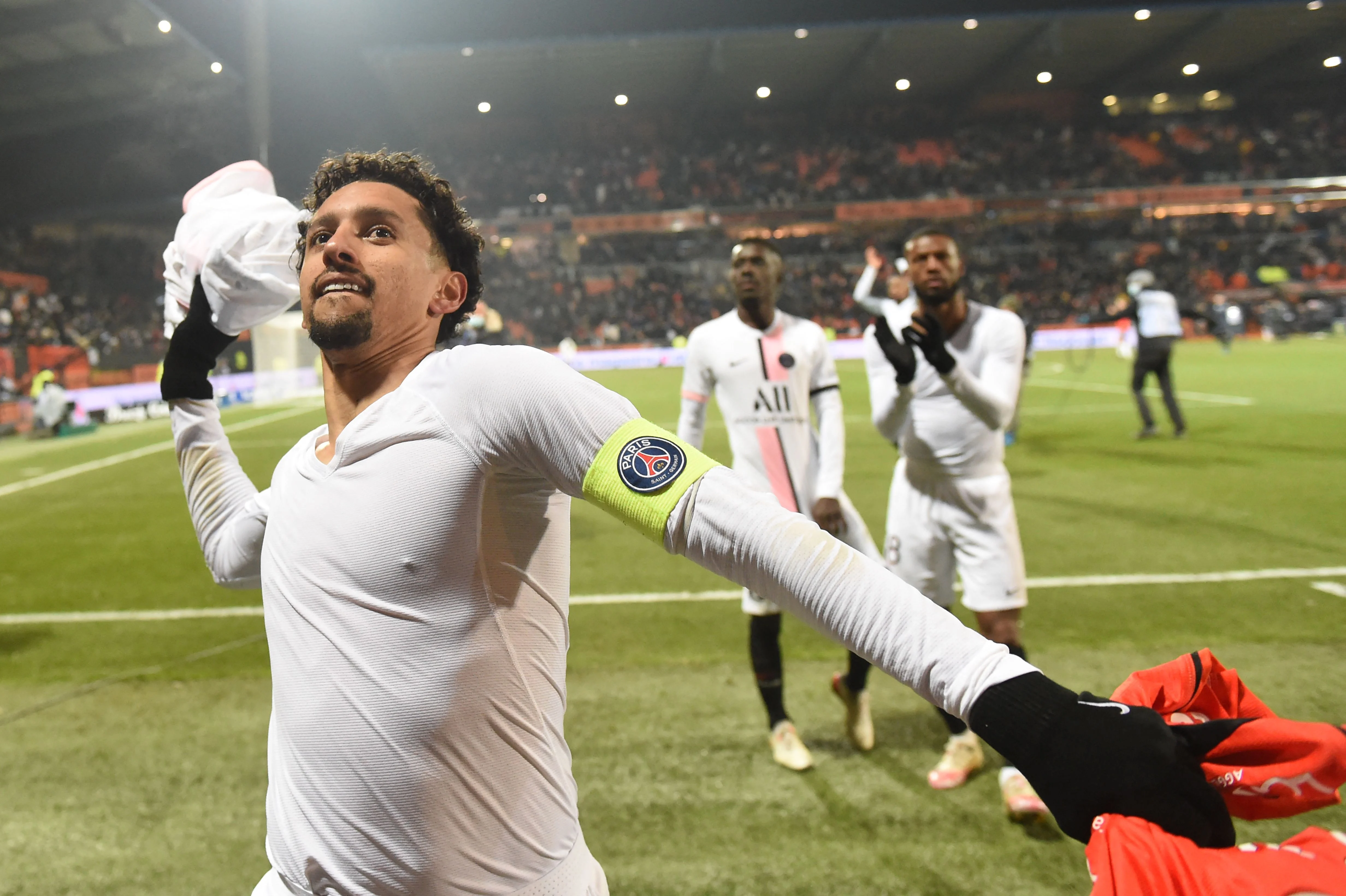 PSG Marquinhos (L) throws his jersey to the supporters at the end of the match