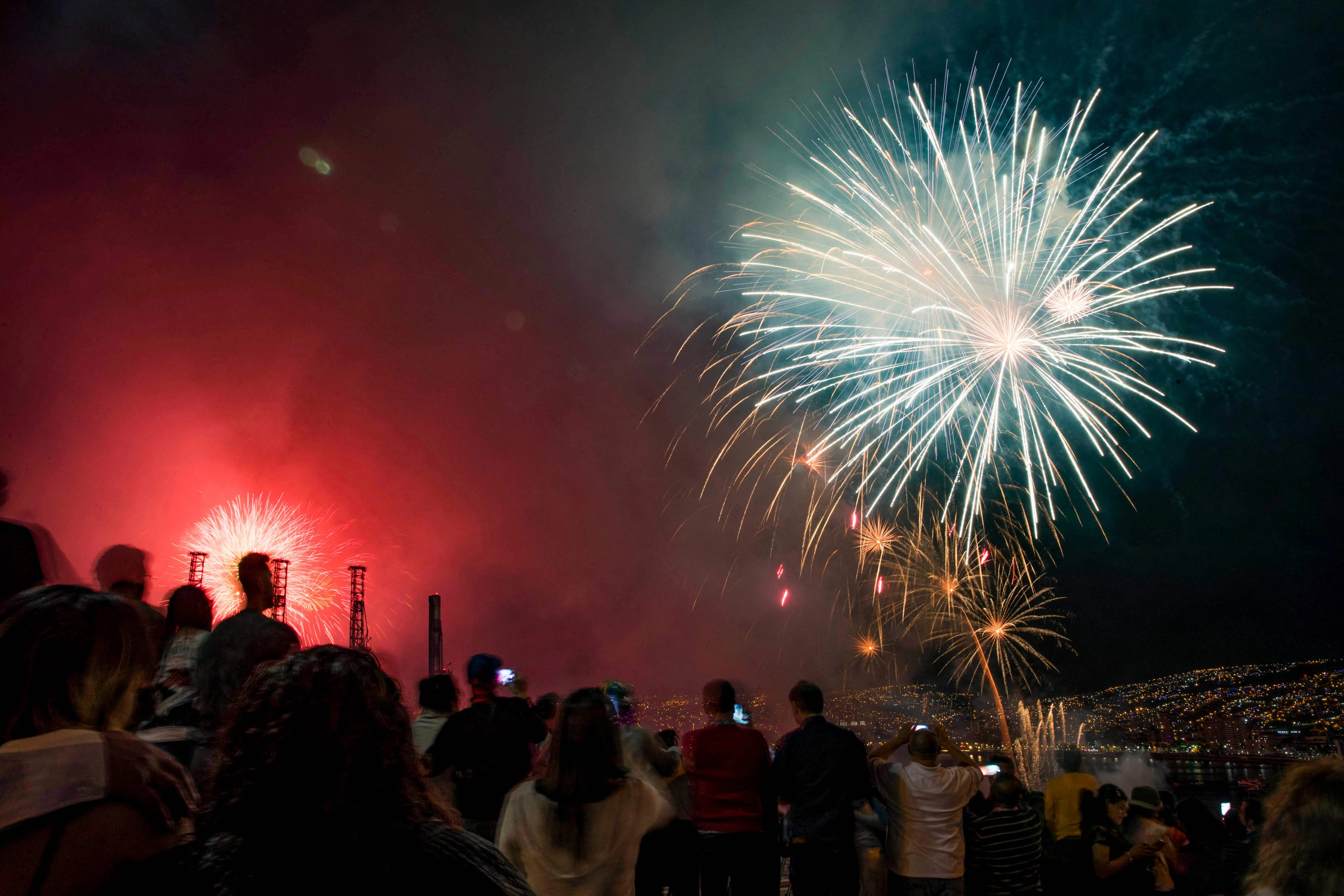 People watch fireworks at the port of Valparaiso on the coast of Chile during New Year celebrations on January 1, 2022.
