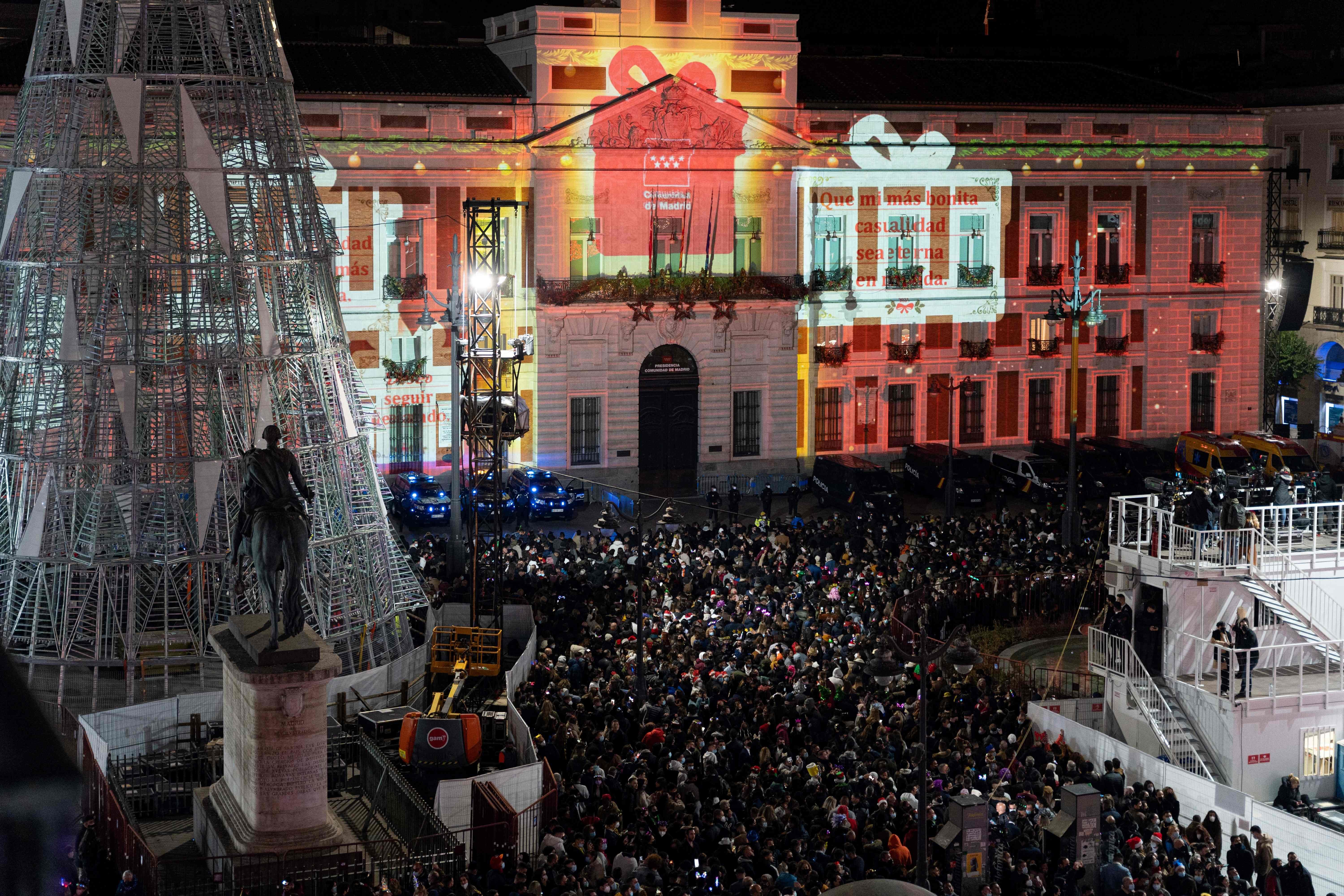 People celebrate New Years Eve on the Puerta Del Sol square in Madrid, on December 31, 2021.
