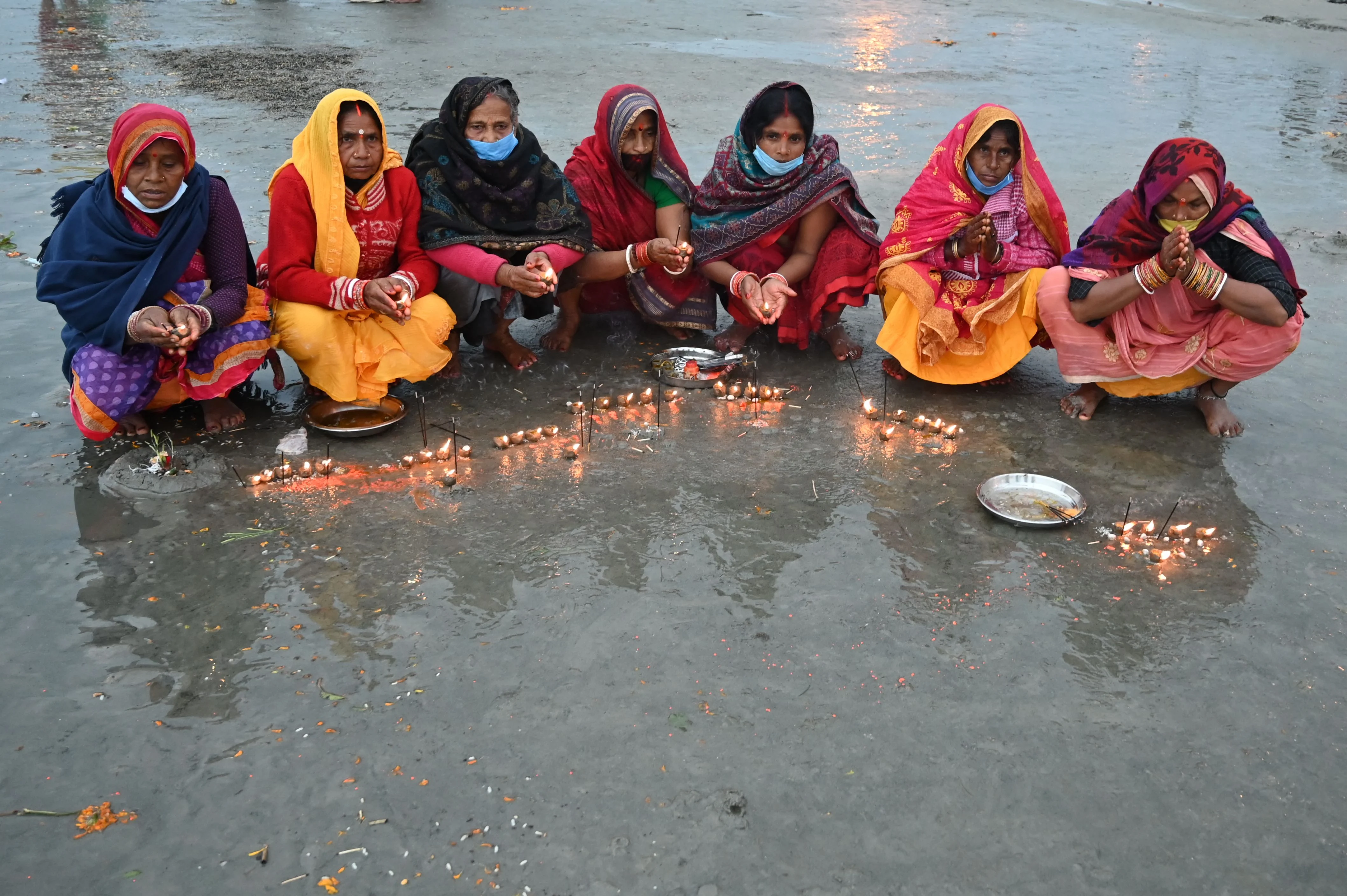 Pilgrims perform rituals on a beach during the Hindu religious festival of Gangasagar Mela on Sagar Island, some 150 km south of Kolkata, West Bengal, on January 13, 2022.