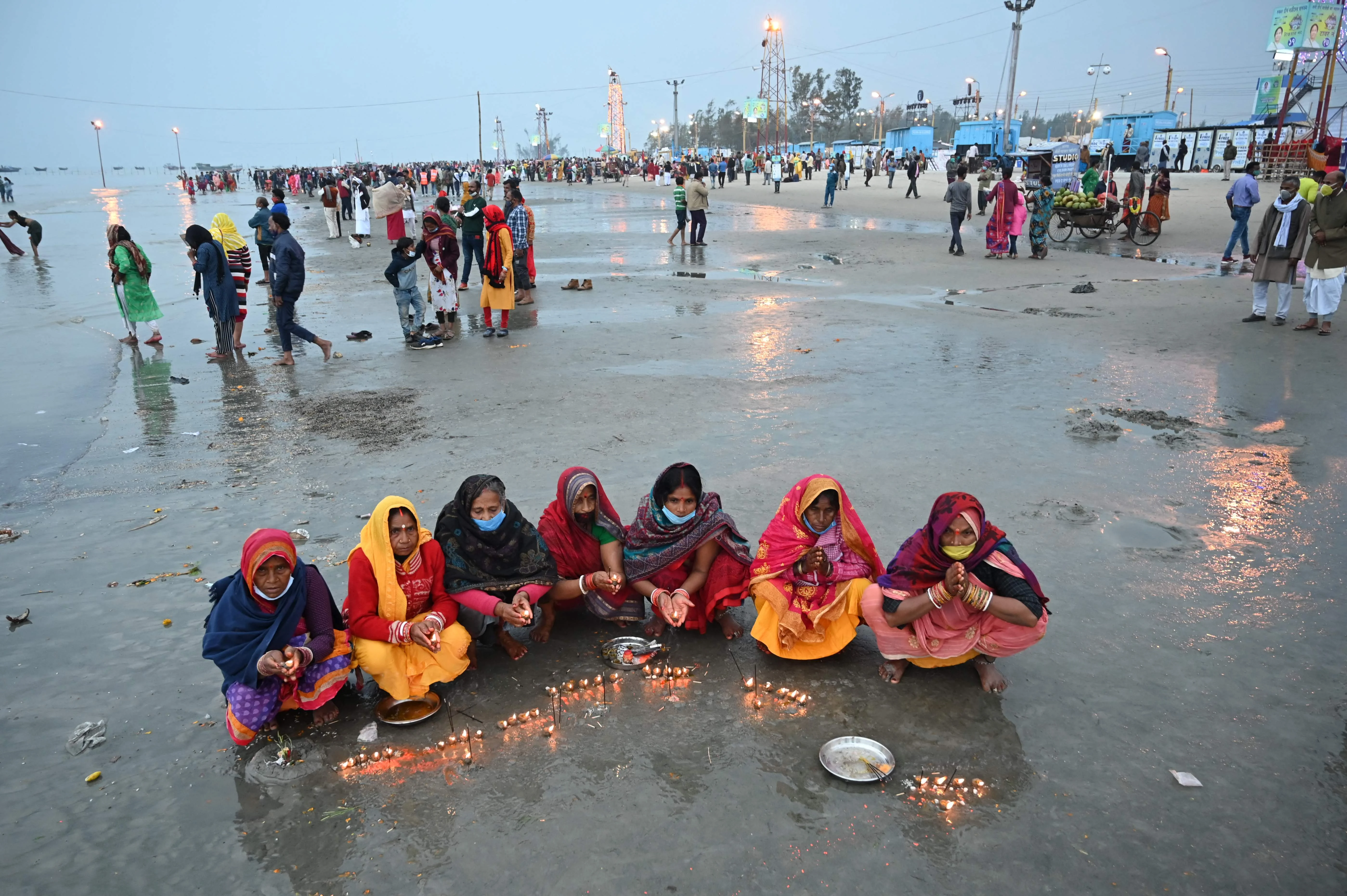 Pilgrims perform rituals during the Hindu religious festival of Gangasagar Mela on Sagar Island, some 150 km south of Kolkata, West Bengal, on January 13, 2022.