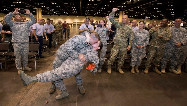 Photo provided by the Orange County government Lauren Durham and Michael Davis kiss after they are married at the Orange County Convention Center in Orange, Fla. The couple, both senior airmen with the Air National Guard, had planned to get married in an intimate ceremony on a beach Sunday, but, they were deployed to help rescue efforts after Hurricane Irma. Stationed at the Orange County Convention Center while waiting for the storm to pass, they decided over breakfast to get married right there, in their fatigues, surrounded by their fellow servicemen and servicewomen, just hours before rushing into the state’s most devastated regions to help their fellow Floridians. Photo provided by the Orange County government Lauren Durham and Michael Davis kiss after they are married at the Orange County Convention Center in Orange, Fla. The couple, both senior airmen with the Air National Guard, had planned to get married in an intimate ceremony on a beach Sunday, but, they were deployed to help rescue efforts after Hurricane Irma. Stationed at the Orange County Convention Center while waiting for the storm to pass, they decided over breakfast to get married right there, in their fatigues, surrounded by their fellow servicemen and servicewomen, just hours before rushing into the state’s most devastated regions to help their fellow Floridians. 