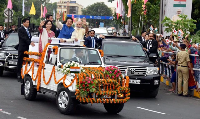 Prime Minister Narendra Modi, Japanese Prime Minister Shinzo Abe and his wife Akie Abe wave from an open vehicle during their roadshow in Ahmedabad on Wednesday. Abe is on a two-day visit to India. Prime Minister Narendra Modi, Japanese Prime Minister Shinzo Abe and his wife Akie Abe wave from an open vehicle during their roadshow in Ahmedabad on Wednesday. Abe is on a two-day visit to India.