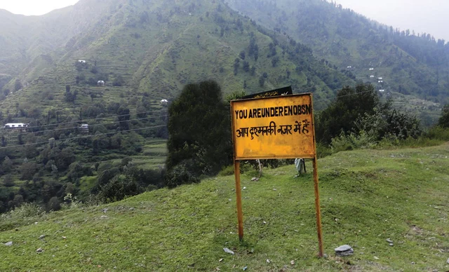 A billboard put up by the Army in a border village Poonch that warns residents of surveillance by Pakistani forces, implying the possibility of coming under enemy fire A billboard put up by the Army in a border village Poonch that warns residents of surveillance by Pakistani forces, implying the possibility of coming under enemy fire