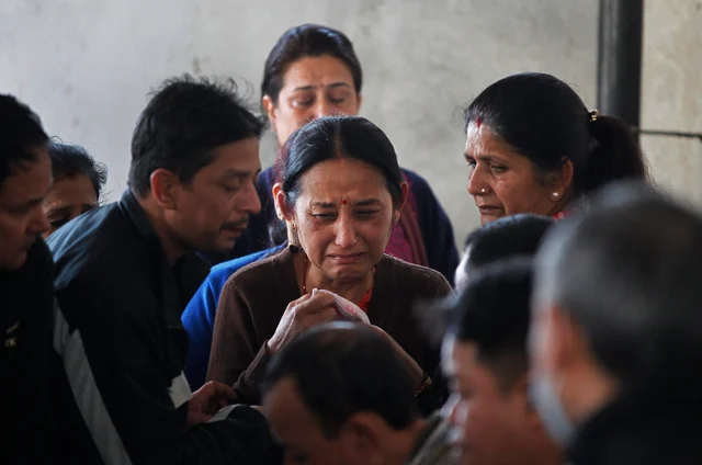 Unidentified family members of a passenger of a Bangladesh’s US-Bangla Flight BS211mourn as they wait to receive the body at the government hospital in Kathmandu, Nepal. Unidentified family members of a passenger of a Bangladesh’s US-Bangla Flight BS211mourn as they wait to receive the body at the government hospital in Kathmandu, Nepal. 