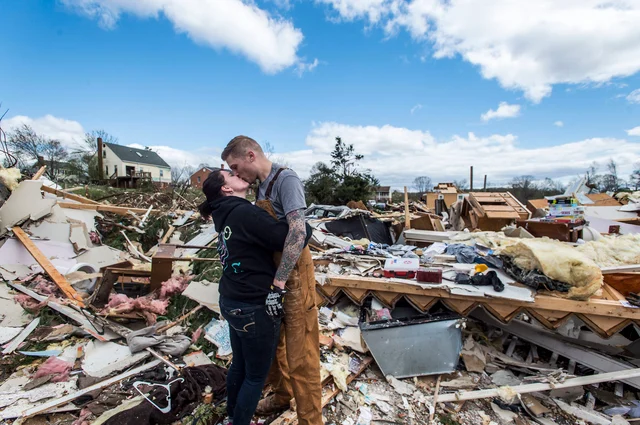 Mia Polaski and her husband Ryan Polaski kiss during a brief moment of respite while clearing debris from her father Randy’s storm damage home, in Elon, Virginia. Virginia’s governor has declared a state of emergency after storms ripped through parts of western Virginia. Mia Polaski and her husband Ryan Polaski kiss during a brief moment of respite while clearing debris from her father Randy’s storm damage home, in Elon, Virginia. Virginia’s governor has declared a state of emergency after storms ripped through parts of western Virginia.