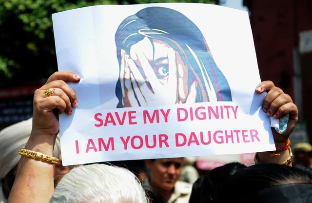A protester staging demonstration against incidents of rape in Unnao (Uttar Pradesh) and Kathua (Jammu and Kashmir) displays a poster saying “Save my dignity, I am your daughter” in Amritsar, A protester staging demonstration against incidents of rape in Unnao (Uttar Pradesh) and Kathua (Jammu and Kashmir) displays a poster saying “Save my dignity, I am your daughter” in Amritsar,