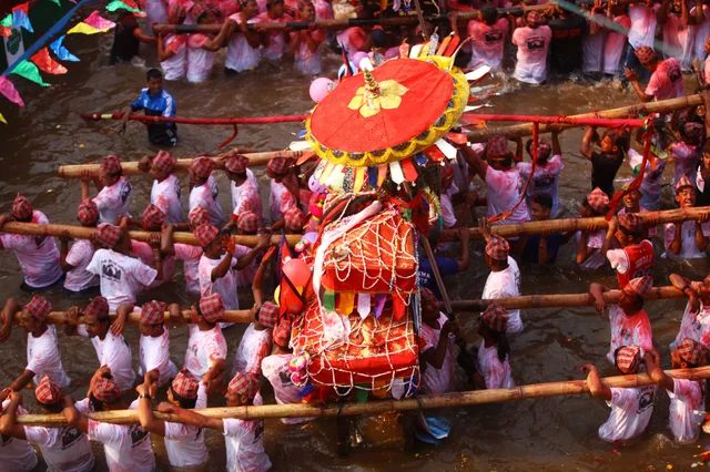 Nepalese people carry chariots on their shoulders in celebration of the Bisket Jatra festival in Tokha of Kathmandu, Nepal. The festival is celebrated with chariot processions of various gods and goddesses to welcome the Nepalese New Year and the beginning of spring in Nepal. Nepalese people carry chariots on their shoulders in celebration of the Bisket Jatra festival in Tokha of Kathmandu, Nepal. The festival is celebrated with chariot processions of various gods and goddesses to welcome the Nepalese New Year and the beginning of spring in Nepal.