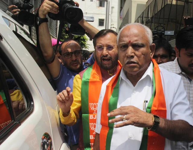 BJP leaders B.S. Yeddyurappa and Prakash Javadekar arrive after meeting Karnataka Governor Vajubhai Vala in Bengaluru. BJP leaders B.S. Yeddyurappa and Prakash Javadekar arrive after meeting Karnataka Governor Vajubhai Vala in Bengaluru.