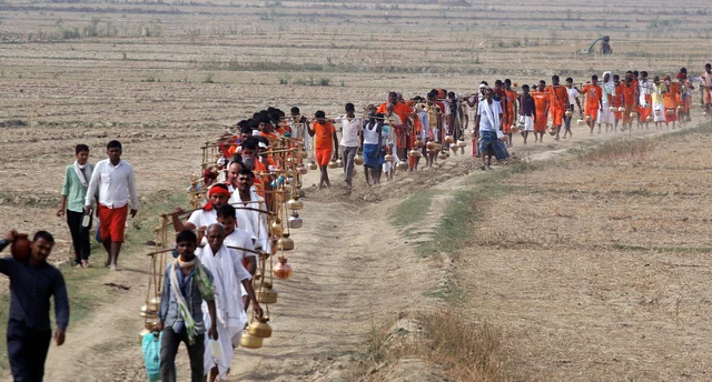Hindu devotees (Kanwariyas) carry holy water of river Ganga to perform ‘abhishek’ at Padilla Mahadev temple, on the 1st day of Purshottam (Adhimas) of Hindu calendar, in Allahabad. Hindu devotees (Kanwariyas) carry holy water of river Ganga to perform ‘abhishek’ at Padilla Mahadev temple, on the 1st day of Purshottam (Adhimas) of Hindu calendar, in Allahabad.