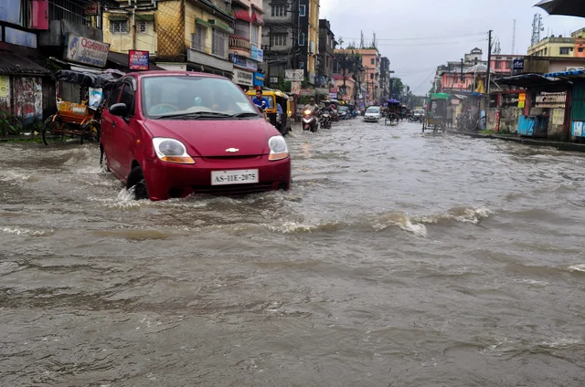 A car wades through a flooded street after heavy downpour in Silchar, Assam. A car wades through a flooded street after heavy downpour in Silchar, Assam.