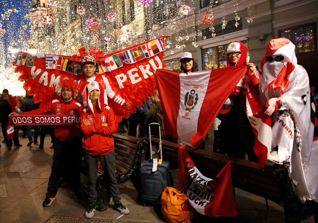 Fans of Peru stand to pose for pictures with passing fans from other countries, as visitors and Russians alike gathered to celebrate and cheer on their teams on the eve of the 2018 soccer World Cup, on Nikolskaya Street in Moscow, Russia. Fans of Peru stand to pose for pictures with passing fans from other countries, as visitors and Russians alike gathered to celebrate and cheer on their teams on the eve of the 2018 soccer World Cup, on Nikolskaya Street in Moscow, Russia.