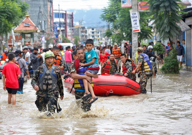 Nepalese army men rescue a sick boy from a flooded area in Bhaktapur, Nepal. The flooding was caused by overflowing of the Hanumante River following heavy rain. Nepalese army men rescue a sick boy from a flooded area in Bhaktapur, Nepal. The flooding was caused by overflowing of the Hanumante River following heavy rain.