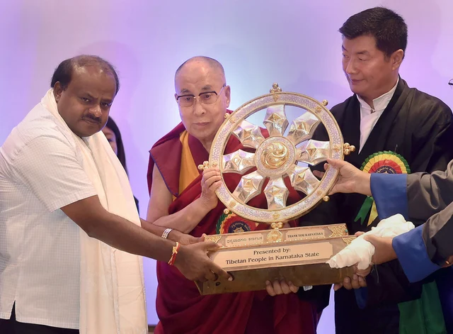 Tibetan spiritual leader Dalai Lama presents a traditional Tibetan memento to Karnataka Chief Minister HD Kumaraswamy during a programme in Bengaluru. Tibetan spiritual leader Dalai Lama presents a traditional Tibetan memento to Karnataka Chief Minister HD Kumaraswamy during a programme in Bengaluru.
