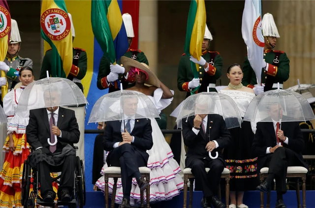 Ecuador’s President Lenin Moreno, from left, Argentina’s President Mauricio Macri, Chile’s President Sebastian Pinera and Mexico’s President Enrique Pena Nieto hold umbrellas during the presidential inauguration ceremony for Ivan Duque, in Bogota, Colombia. Ecuador’s President Lenin Moreno, from left, Argentina’s President Mauricio Macri, Chile’s President Sebastian Pinera and Mexico’s President Enrique Pena Nieto hold umbrellas during the presidential inauguration ceremony for Ivan Duque, in Bogota, Colombia. 
