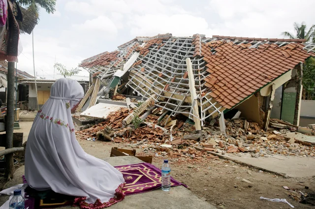 A woman performs a prayer in front of debris from Sunday’s earthquake in West Lombok, Indonesia. Scientist say the powerful Indonesia earthquake that killed more than 300 people lifted the island it struck by as much as 25 centimeters. A woman performs a prayer in front of debris from Sunday’s earthquake in West Lombok, Indonesia. Scientist say the powerful Indonesia earthquake that killed more than 300 people lifted the island it struck by as much as 25 centimeters.