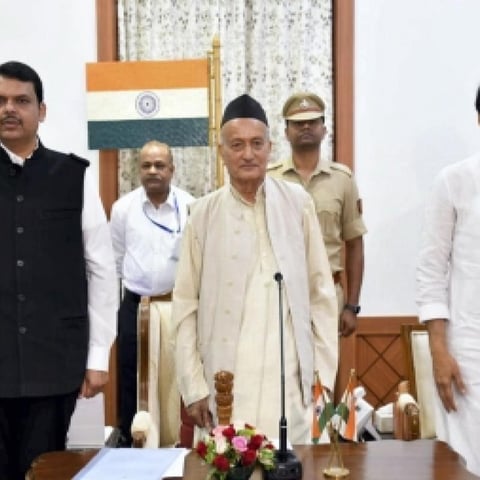 BJP’s Devendra Fadnavis and NCP rebel Ajit Pawar with Governor BS Koshyari after an early morning swearing in on Saturday, Nov 23.