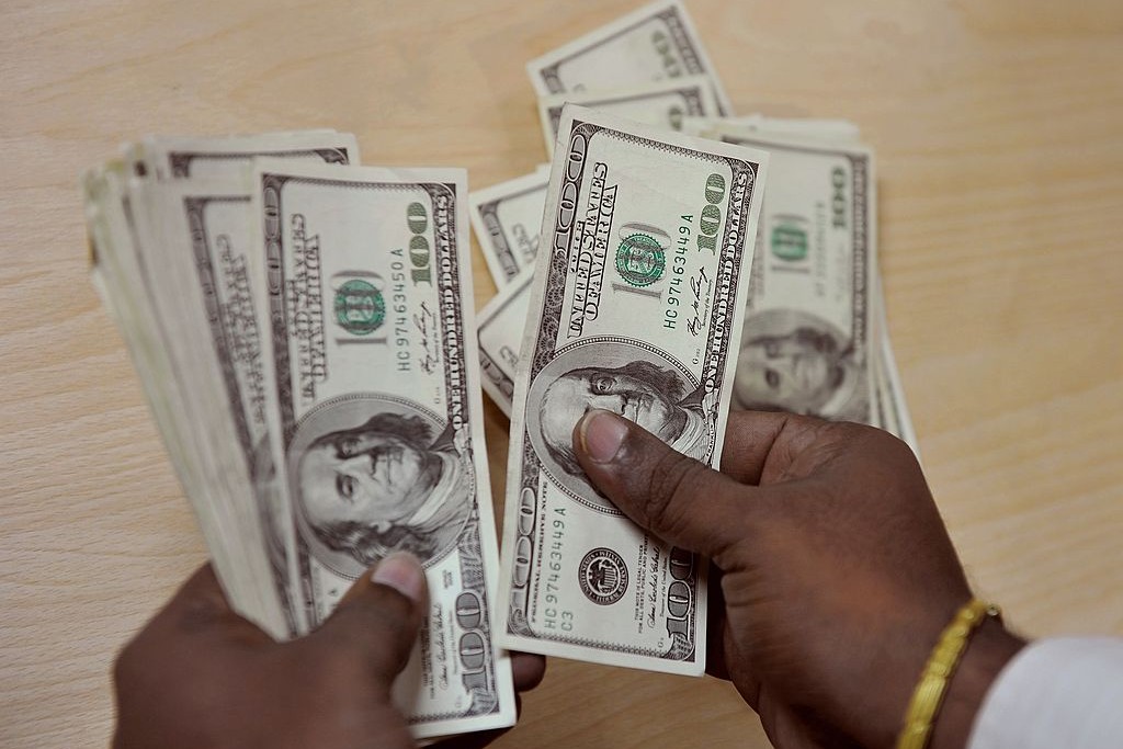 How Russian Dollar Off Will Impact Rbi S Balance Sheet And A Customer Counts Dollars At Money Exchange Desk In India Strdel Afp