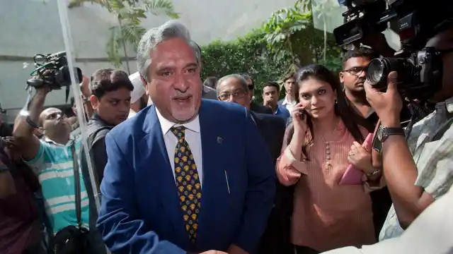 Kingfisher Airlines Chairman Vijay Mallya (C) shakes hands with a well-wisher as he arrives for a news conference in Mumbai November 15, 2011 (Photo: Reuters)