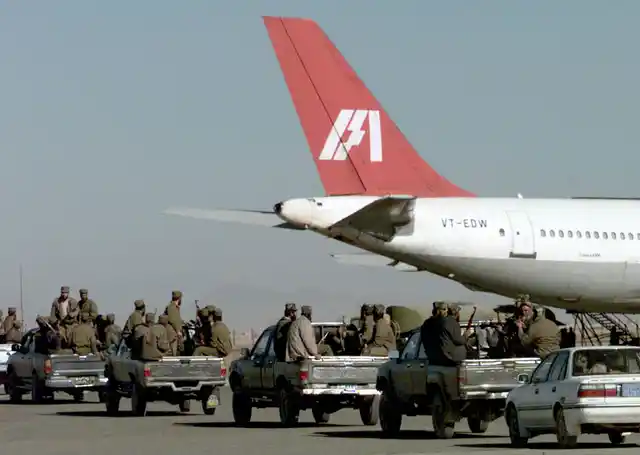 Armed Taliban forces take position near the IC-814 at Kandahar airport. 