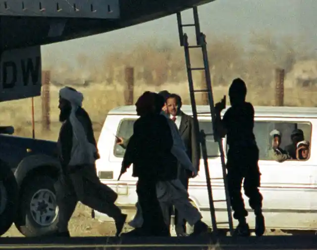 Masked hijackers and Taliban leaders guard IC-814 at the Kandahar airport, Afghanistan. 