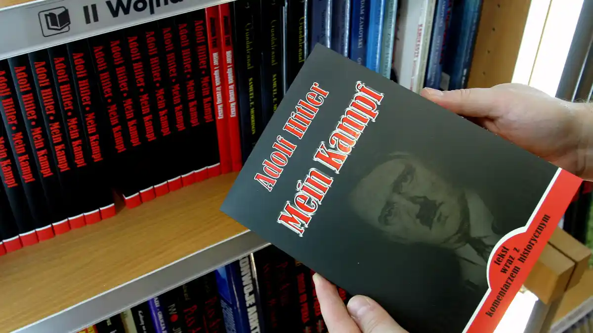 A customer holds a copy of Adolf Hitler’s <i>Mein Kampf</i>.