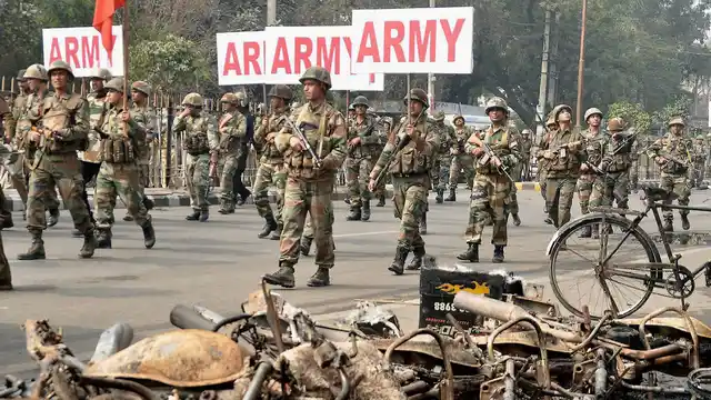 Rohtak: Indian Army men conducting Flag March on Saturday after protests for OBC status for Jats turned violent. (Photo: PTI)