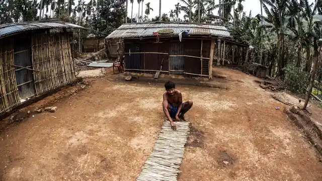 One Rabha man drying bamboo sticks in the front yard of his house. (Photo Courtesy: Anuraag Baruah)