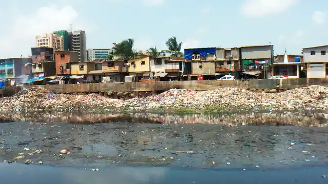 Gyaneshwar Nagar slum plot in Bandra (East) from across the Mithi river. 
