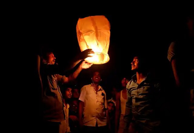 Indians light a sky lantern to celebrate Diwali festival in New Delhi, India, Thursday, Oct. 19, 2017.