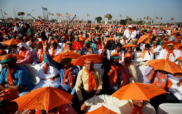 Supporters of India’s ruling Bhartiya Janta Party (BJP) wait for Prime Minister Narendra Modi to address a public rally at Bhaat village on the outskirts of Ahmedabad, India October 16, 2017.