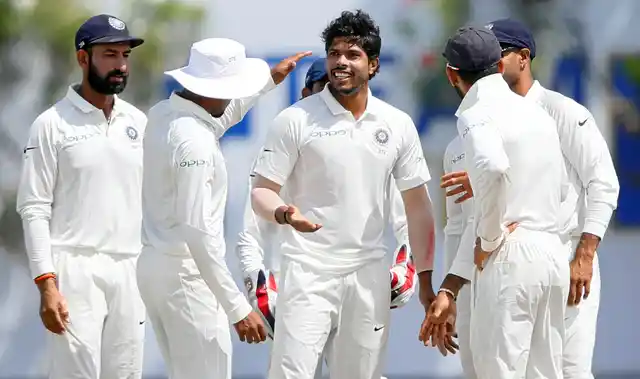 Umesh Yadav celebrates a wicket with his teammates.