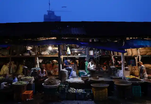 Vendors wait for cutsomers at their stalls at a wholesale vegetable market in Mumbai, India, October 16, 2017. 