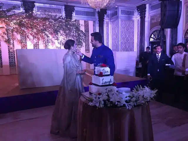 Zaheer and Sagarika feed each other the reception cake.