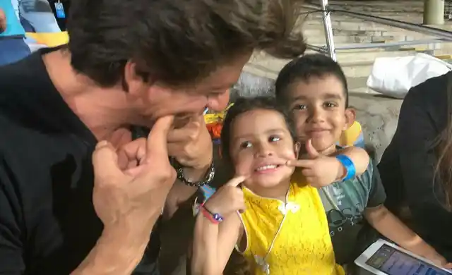 Shah Rukh Khan coaches Ziva Dhoni in the stands.