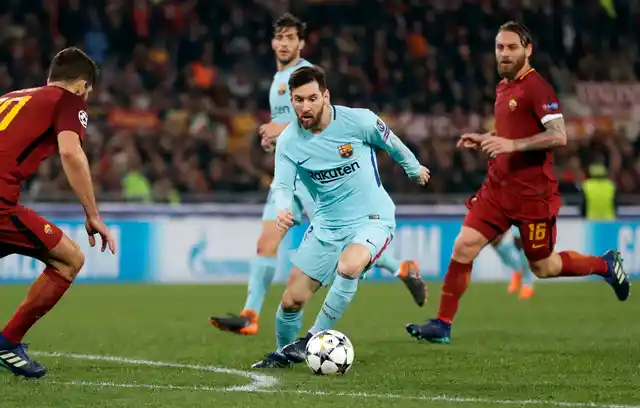 Barcelona’s Lionel Messi wins with the ball during the Champions League quarter-final second leg soccer match.