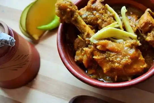 Chicken curry with raw mangoes.