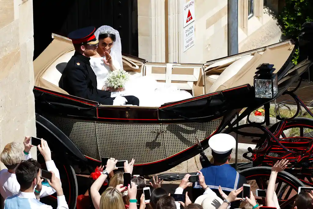 Britain’s Prince Harry and Meghan Markle leave in a carriage after their wedding ceremony at St George’s Chapel in Windsor Castle in Windsor, near London, England, Saturday, 19 May, 2018.